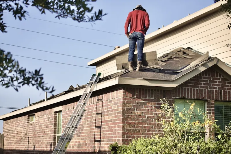 Professional roofer working on a residential roof in Miracle Mile